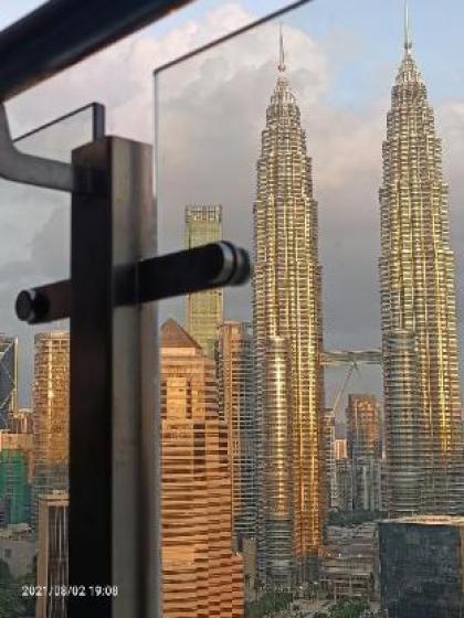 Legasi whitish twin tower view next to LRT train - image 10