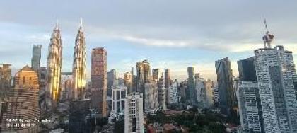 Legasi whitish twin tower view next to LRT train - image 13