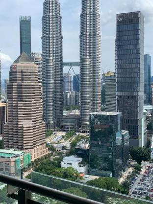 Legasi whitish twin tower view next to LRT train - image 2