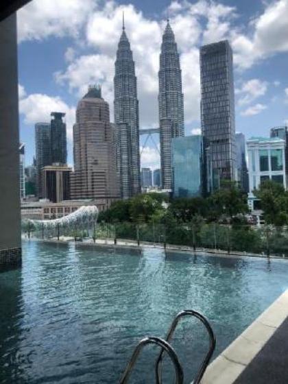 Legasi whitish twin tower view next to LRT train - image 6